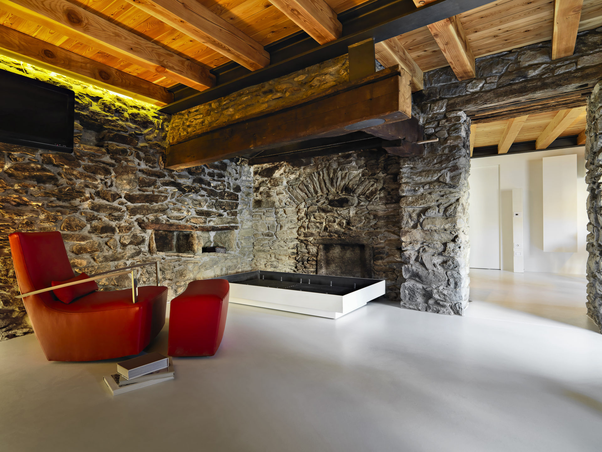 Interior Shots Of A Rustic Living Room With Resin Floor In The Foreground The Leather Armchair And The Rustic Fireplace The Walls Are Made Of Stone