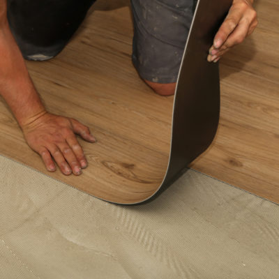 The Worker Installing New Vinyl Tile Floor
